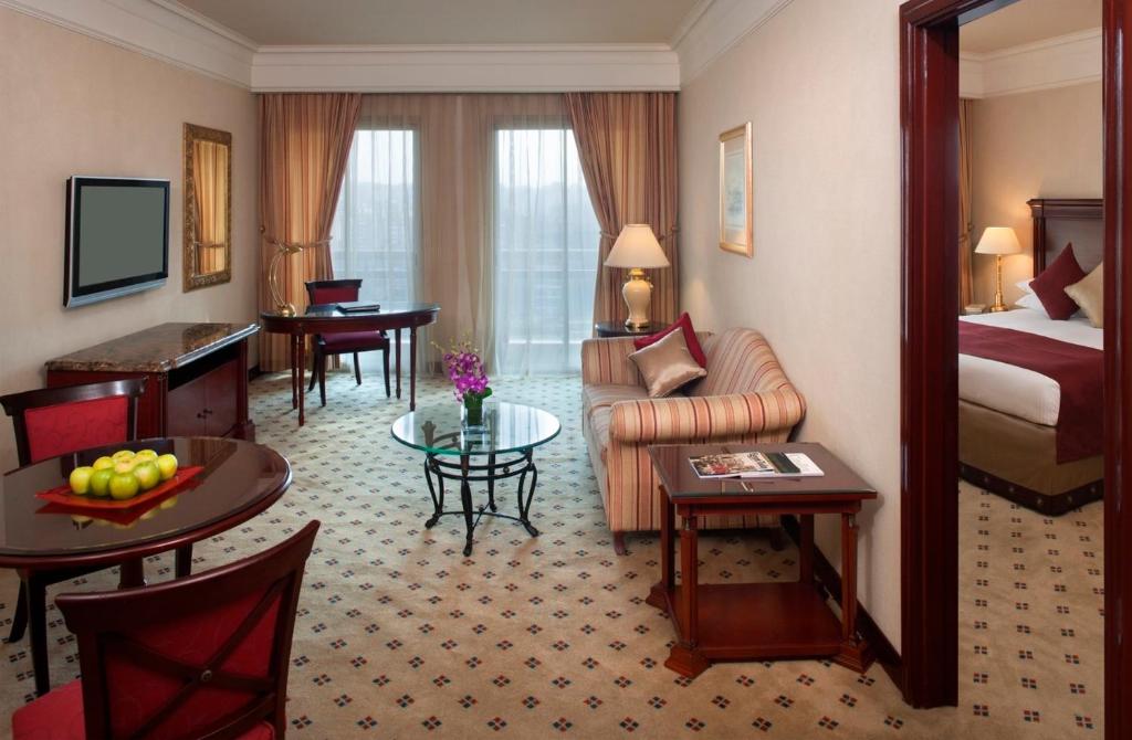 a hotel room with a bed and a living room at Intercontinental Cairo Citystars by IHG in Cairo