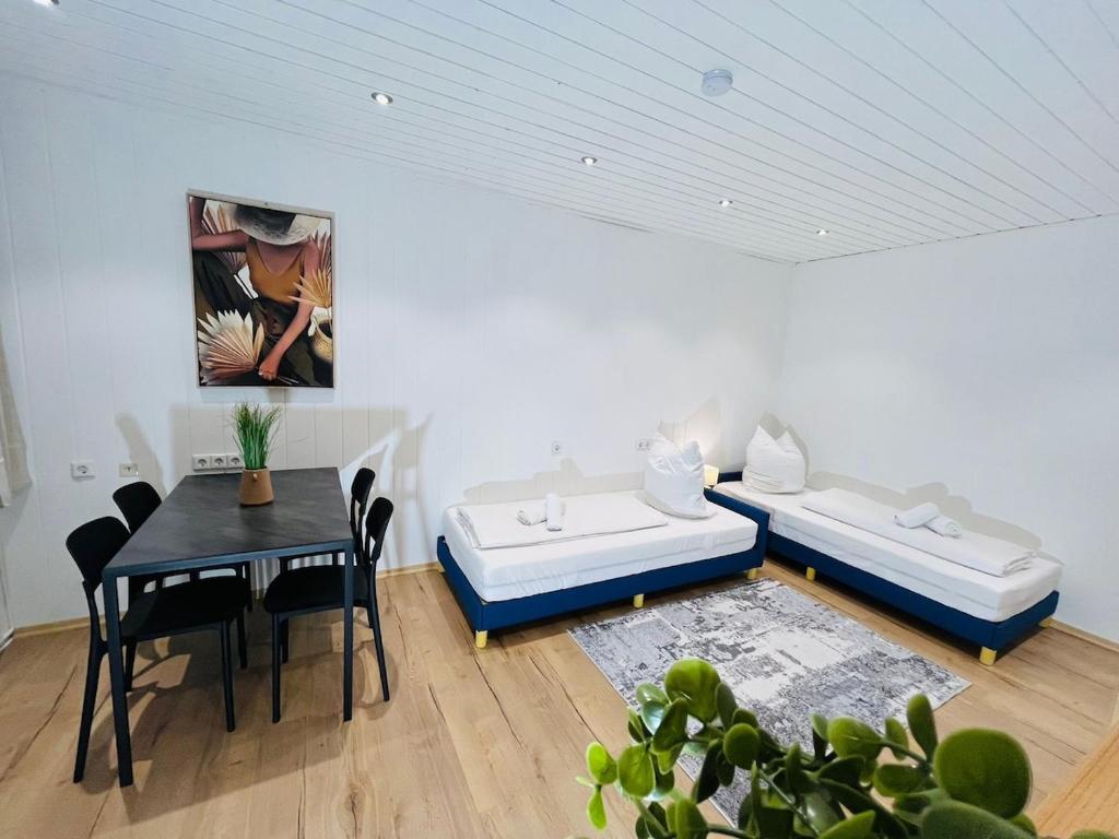 a living room with two beds and a table at Ferienwohnung Südtor 2 in Geisingen