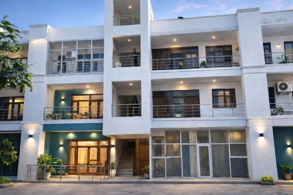 an exterior view of a white building at Esadan in Agra