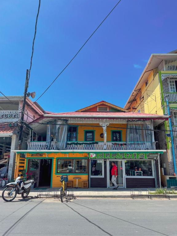 a yellow building on the side of a street at Calipso Bocas Town - Cozy Caribbean House in the Center in Bocas Town