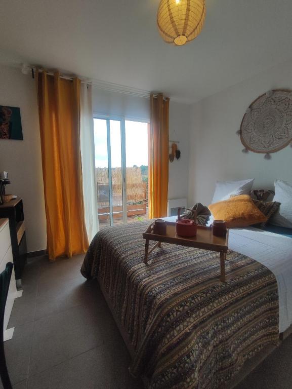 a bedroom with a bed with a table on it at O'me Wally in Galargues