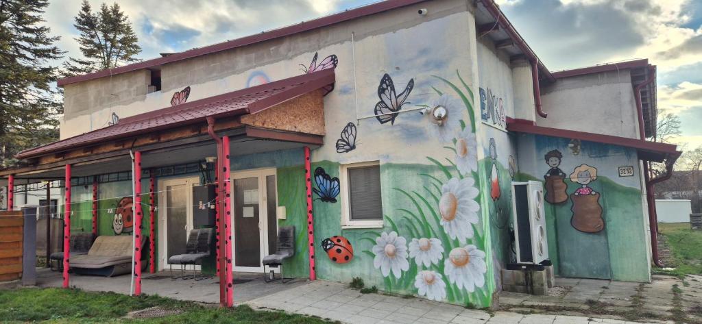 a building with a painting on the side of it at turistická ubytovňa LIENKA in Holíč