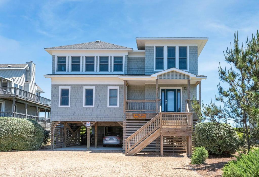 a large house with a porch and a deck at Run-A-Way Bay - Duck, Sanderling, Oceanfront, Ocean View, Hot Tub, Community Pool, Tennis in Duck