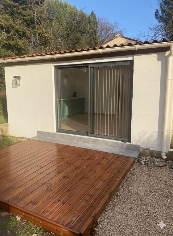 a deck with a sliding glass door on a house at Aurora in Montauroux