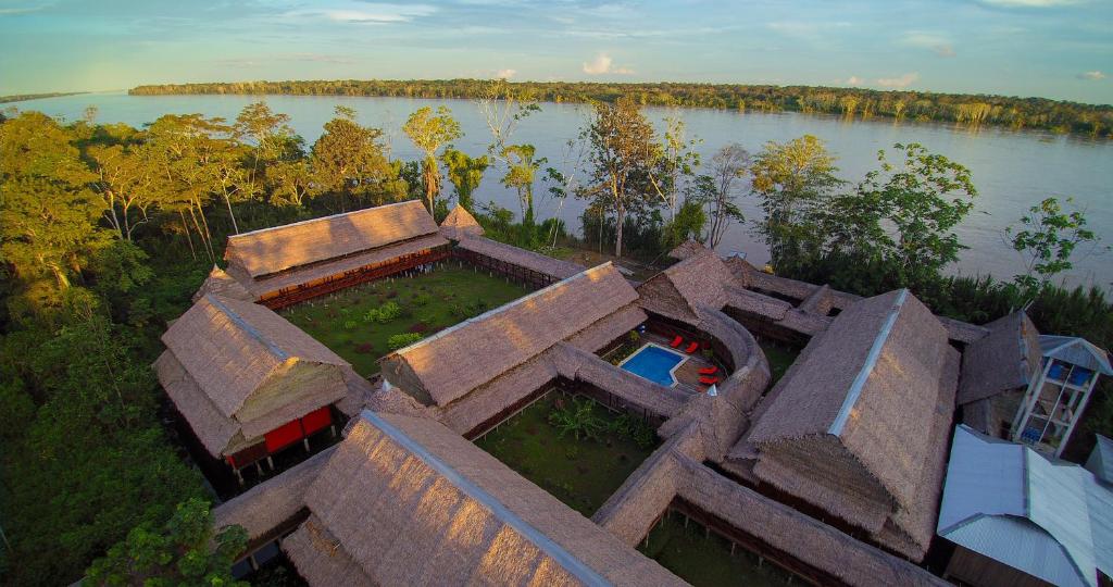 an aerial view of a house by a lake at Heliconia Amazon River Lodge in Francisco de Orellana