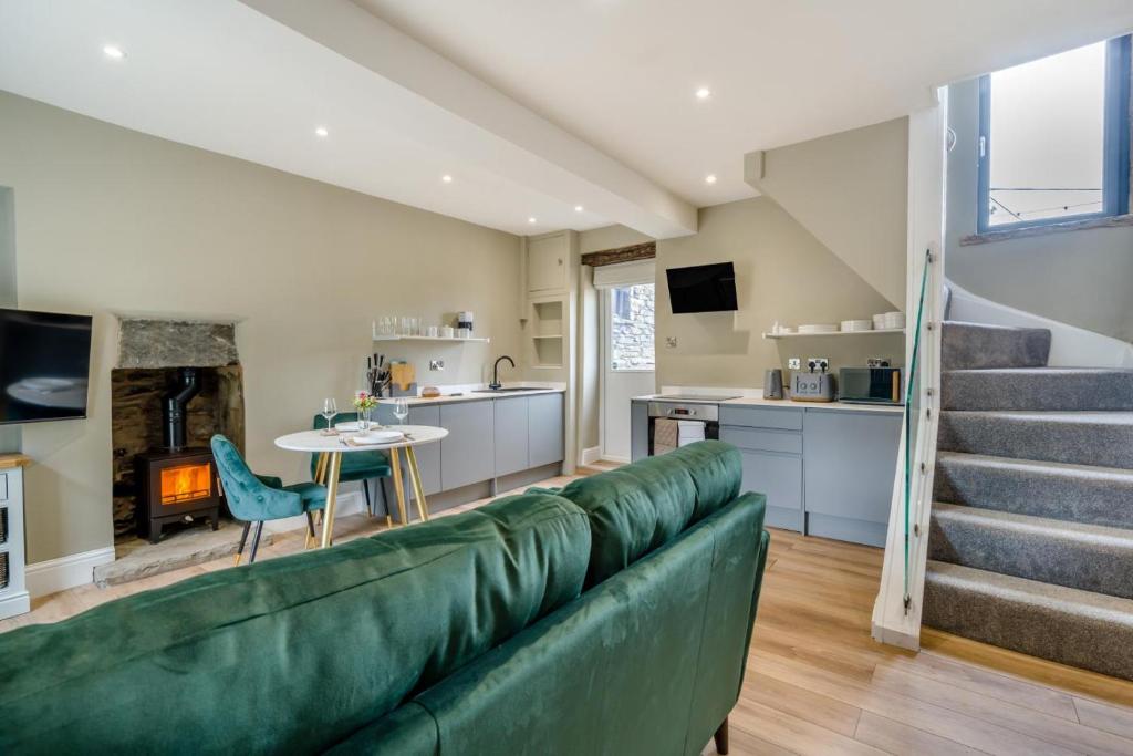 a living room with a green couch and stairs at 1 Bed in Tebay oc-m29886 in Tebay