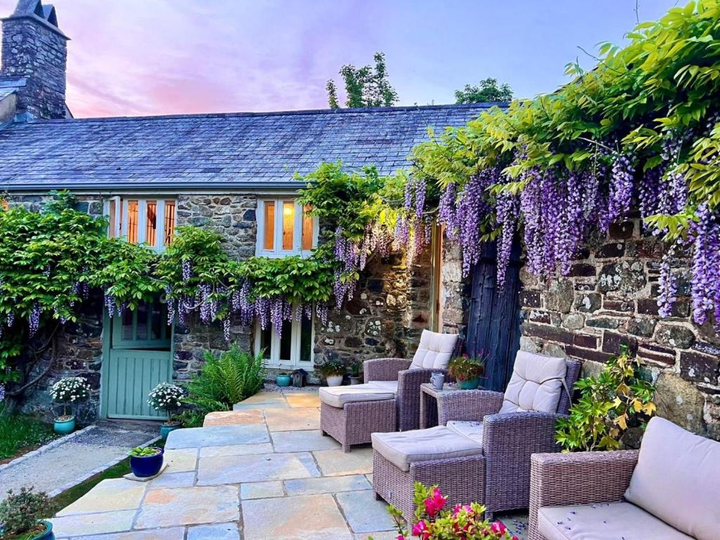 a stone house with purple wisteria growing on it at 2 Bed in Kelly oc-k29333 in Kelly