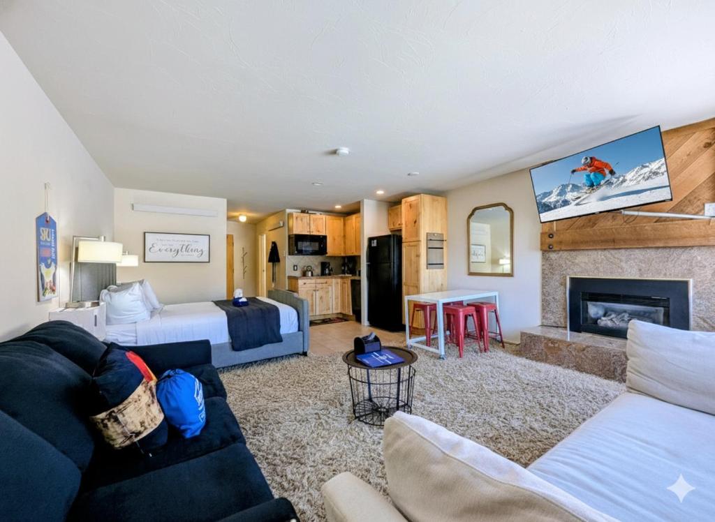 a hotel room with a bed and a living room at Edgewater 1436 by SummitCove Lodging in Colorado in Keystone