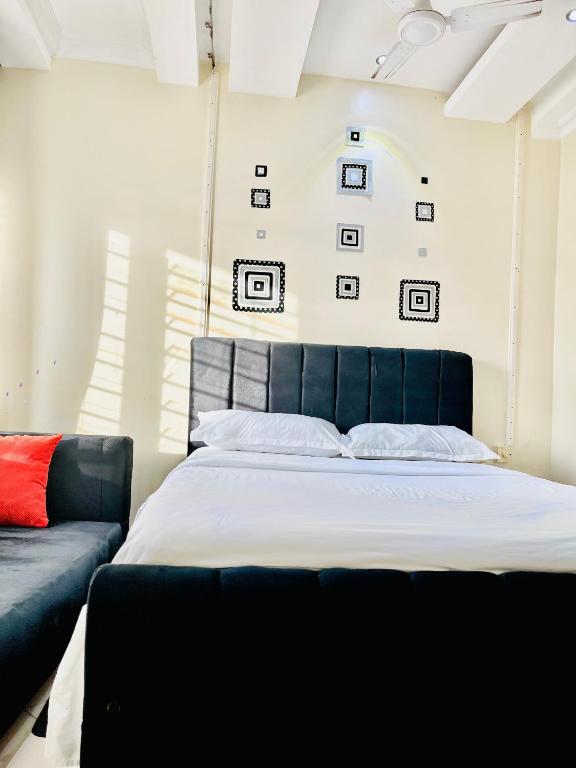a bedroom with a blue bed and a couch at B&S Studio apartment 1 , Voi Town in Voi