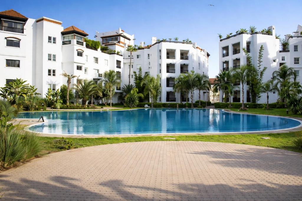 a large swimming pool in front of some buildings at Marina Executive Suites in Agadir
