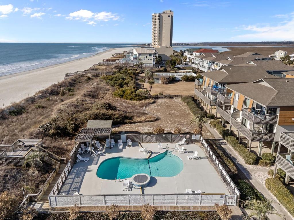 an aerial view of the beach with a pool and the ocean at OIB90 Endless Summer in Ocean Isle Beach