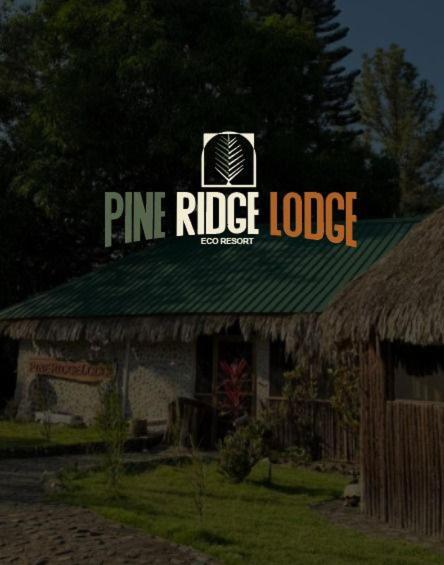 a pine ridge lodge sign on the top of a building at Pine Ridge Lodge Belize in San Ignacio