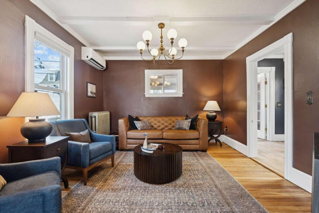 a living room with a couch and a table at State St Parlor Walk Downtown Newly Designed in Portsmouth