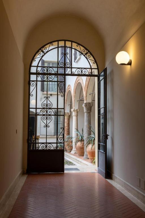 an entrance to a building with a large glass door at Casa Petrucci 2 centro storico, accesso ztl e park gratuito in Forlì