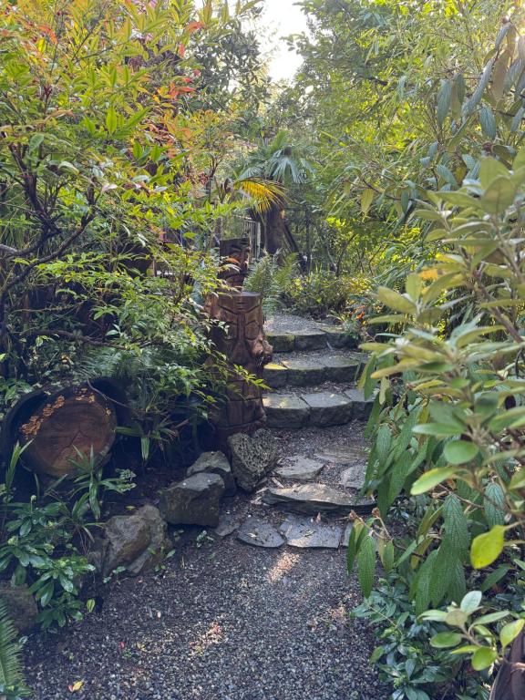 a stone path in a garden with plants at Magnolia Petal Accommodation in Salt Spring Island