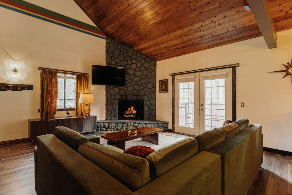 a living room with a couch and a fireplace at The Burgundy in Big Bear Lake