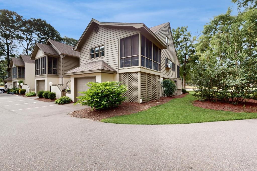 a large house with a driveway at SB25 Clubhouse Villa 3BR in Sunset Beach