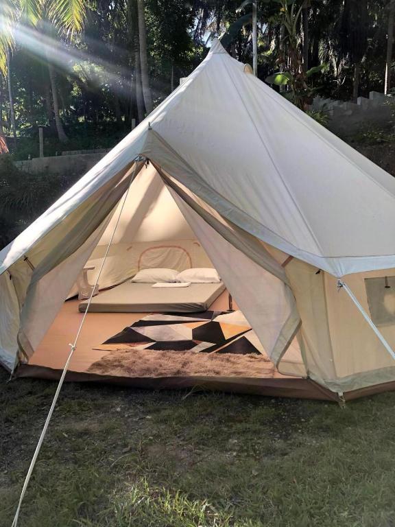 a white tent is set up in the grass at Campo De Laiya in San Juan