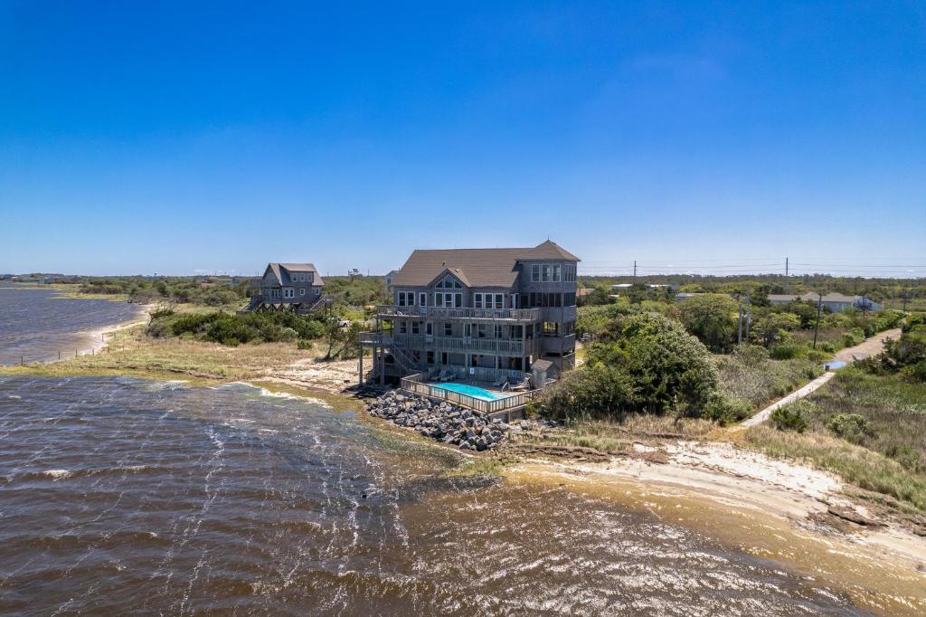 an aerial view of a house on an island in the water at 8650 - Mare Vista Retreat in Frisco