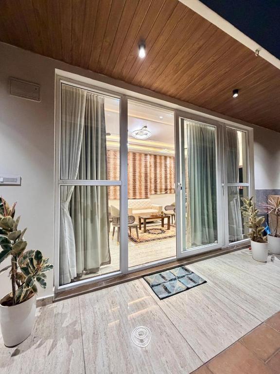 a room with sliding glass doors with a patio at Dar E Noor in Hyderabad