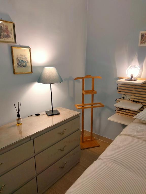 a bedroom with a dresser with a lamp on it at Arthouse in Molfetta