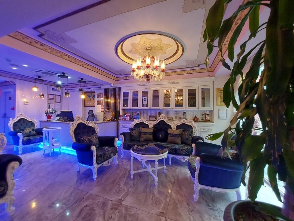 a large living room with couches and a chandelier at Leyenda Boutıque Hotel in Istanbul