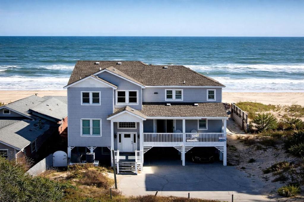 a house on the beach with the ocean behind it at SN8023 - Pier Bliss in Whalebone