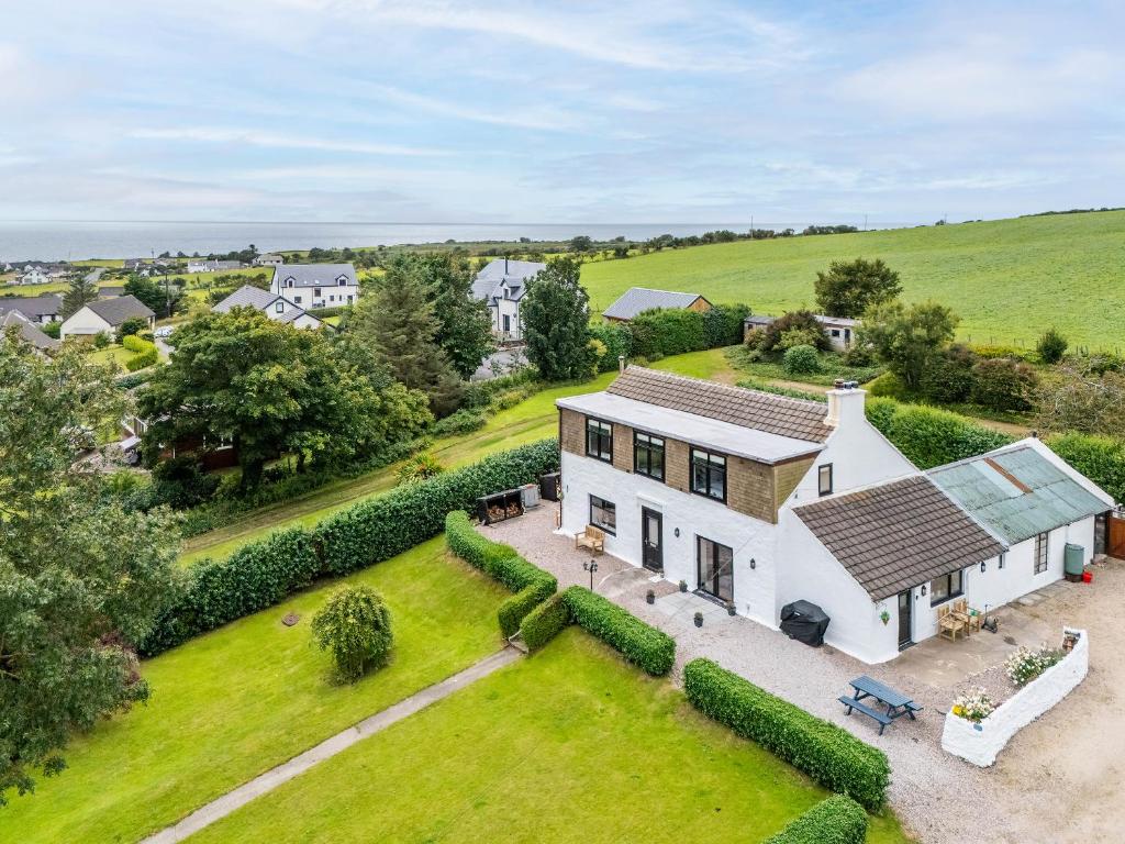an aerial view of a white house with a yard at Greenhill in Blackwaterfoot