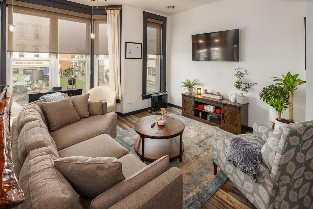 a living room with a couch and a table at The Alibi- We will cover for you in Port Clinton