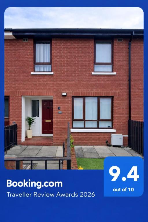 a red brick house with a table in front of it at 293 Holiday Home in Belfast