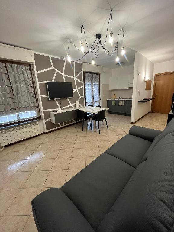 a living room with a couch and a table at AlbaChiara Apartment in Gallarate