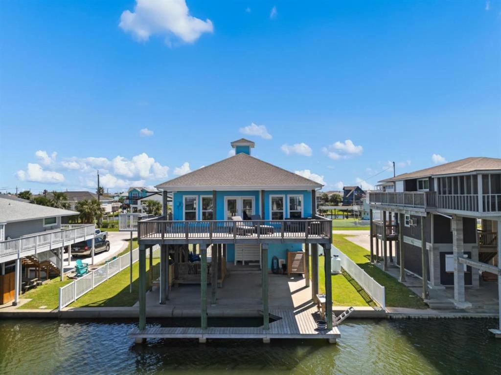 a large house on a dock in the water at Dockside Dream Home for 10 in Galveston