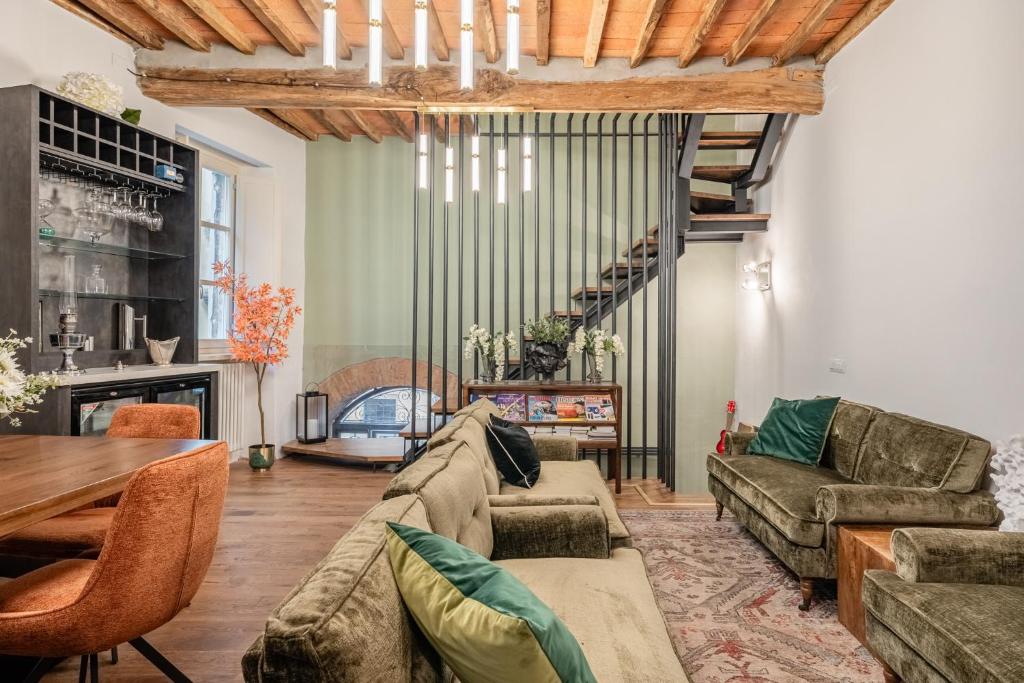 a living room with a couch and a table at The Townhouse Barga in Barga