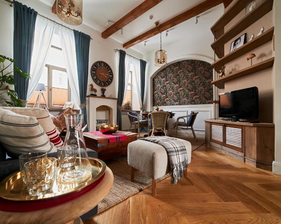 a living room with a couch and a table at Luxury OldTown Free Parking in Vilnius