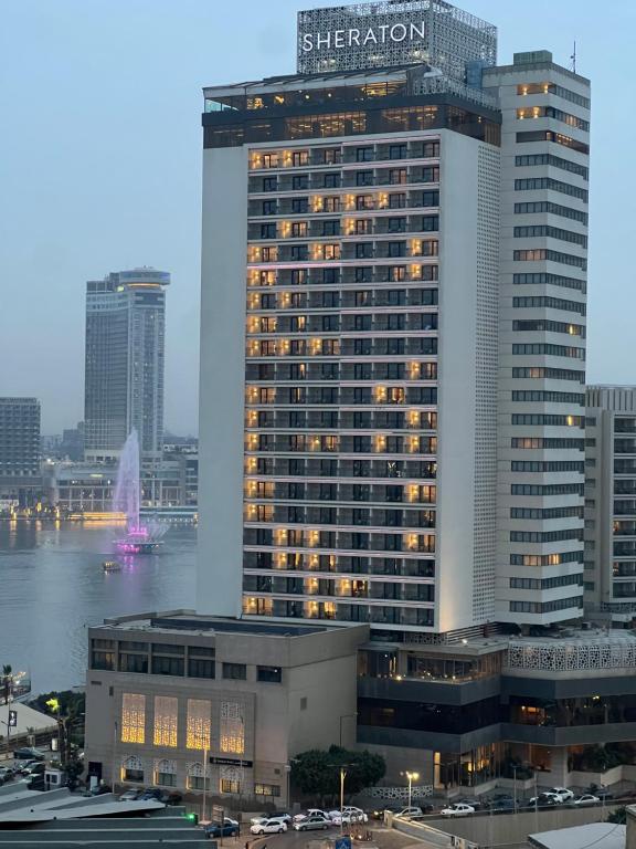 a large building with lights on in a city at Deluxe Apartment Partial Nile View in Cairo
