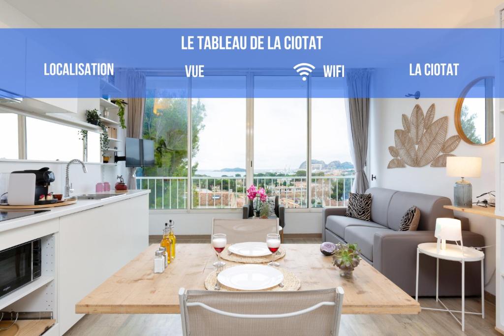 a kitchen and living room with a table and a couch at Tableau de La Ciotat - Host Provence in La Ciotat