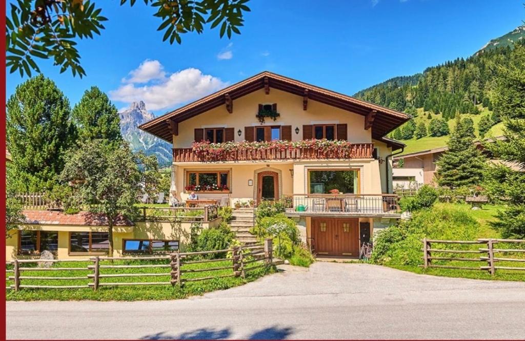 a house in the mountains with a fence at Haus Traudl in Filzmoos