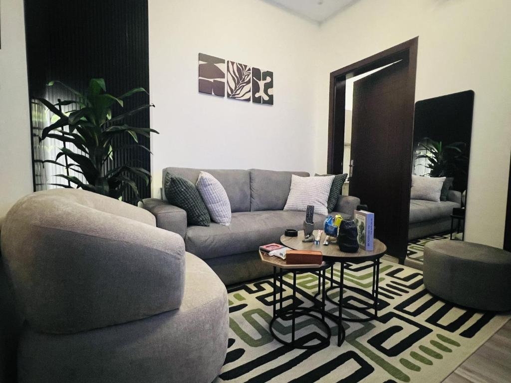 a living room with a couch and a table at Modern Apartment 3 in Jeddah