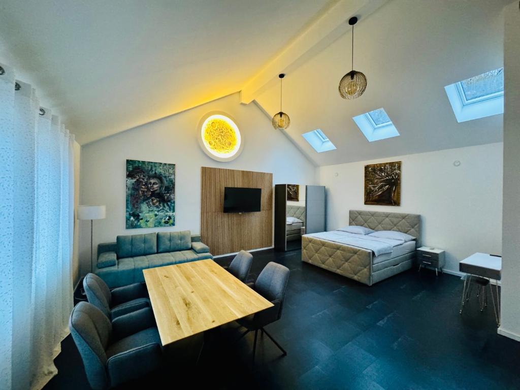 a living room with a bed and a table at Erdeis Apartments in Krems an der Donau
