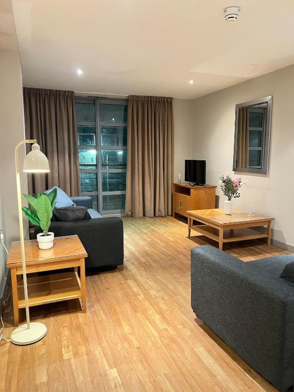 a living room with two couches and a tv at Comfy 2bed flat next to Motorpoint Arena in Nottingham