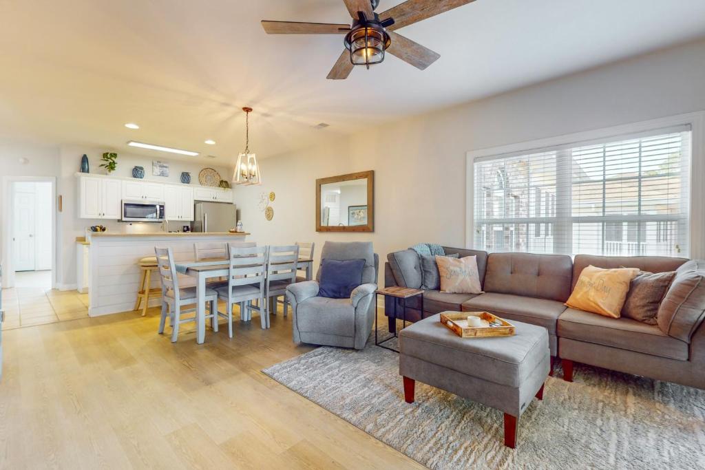 a living room with a couch and a table at SB72 Sea Trail Golf-Beach Condo in Sunset Beach