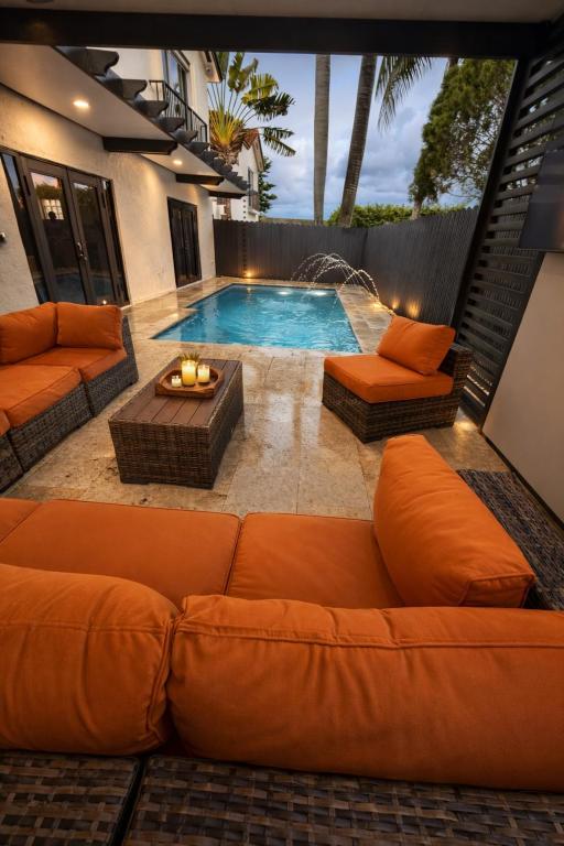 a living room with a couch and a swimming pool at Villa Miami Lakes 2 in Hialeah