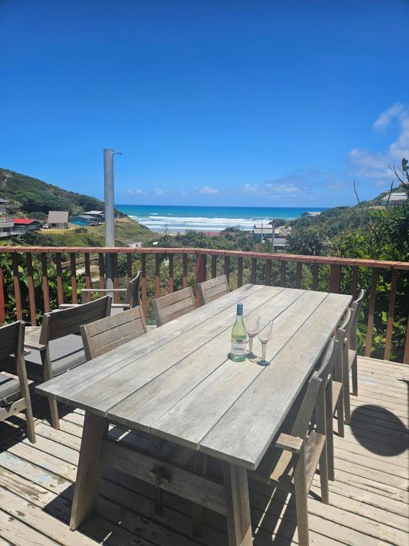 a wooden table with a wine glass sitting on a deck at The Castle in Baylys Beach