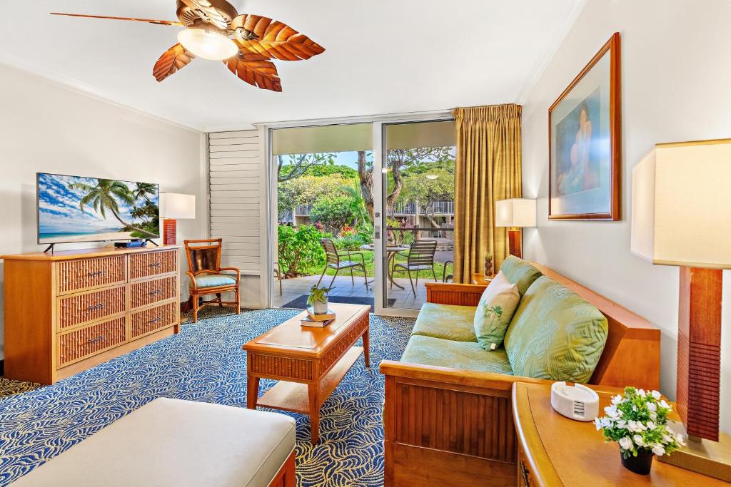 a living room with a couch and a tv at Napili Shores E135 in Kapalua