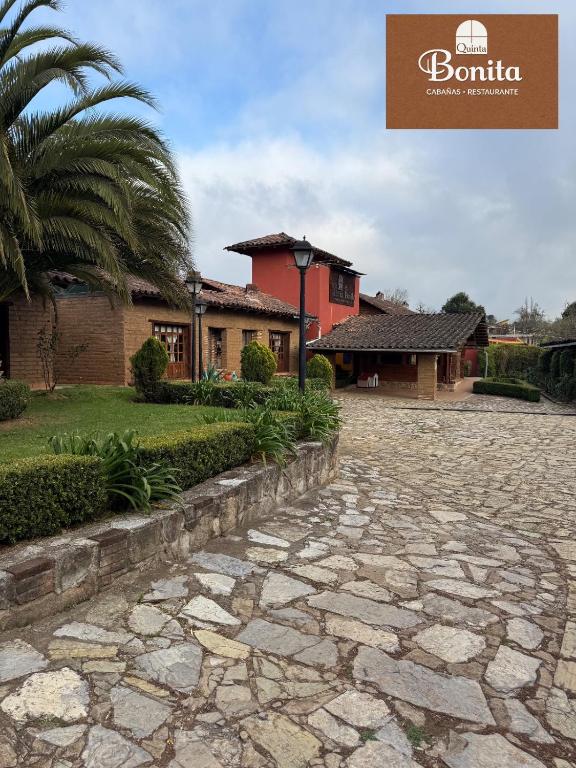 a stone walkway in front of a building at Quinta Bonita in Zacatlán