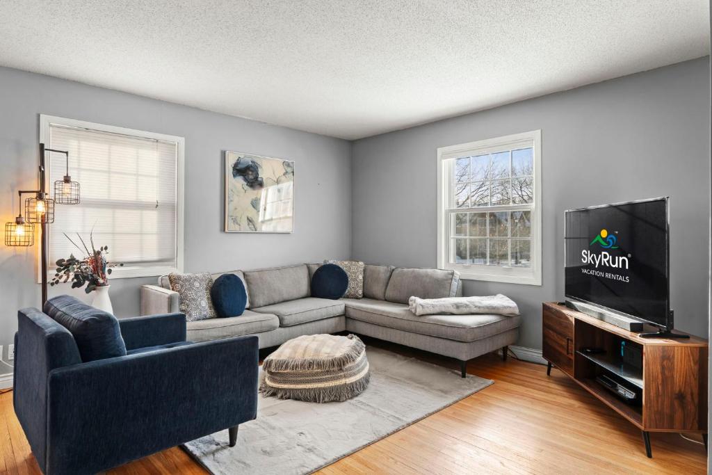 a living room with a couch and a tv at The Nicollet Nook Unit 2 in Minneapolis