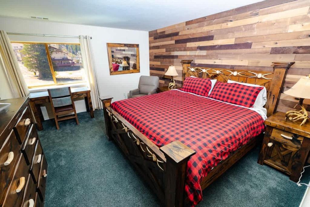 a bedroom with a bed and a table and a window at Ski in out King bed Suite Mountain View in Kirkwood