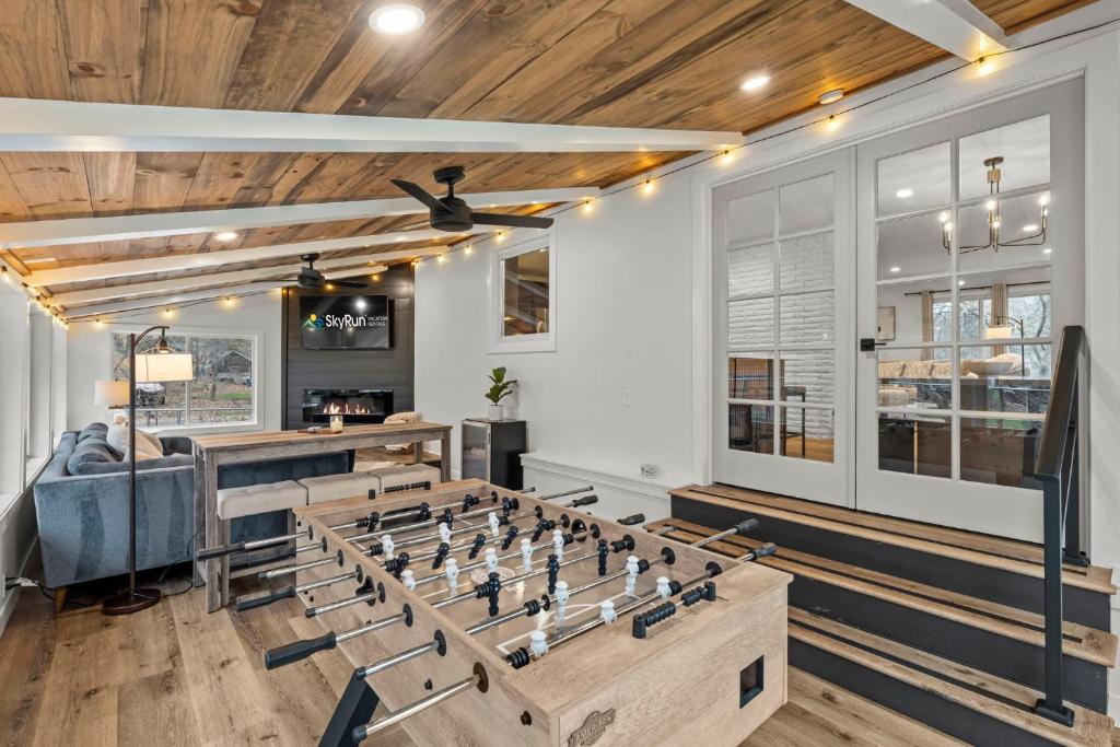 a room with a foosball game in the middle at The Covington Haus in Minnetonka