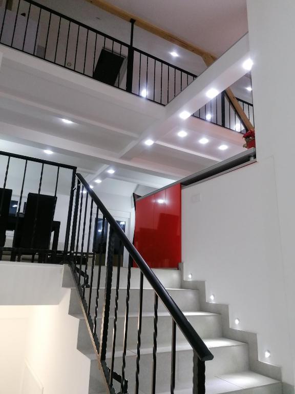 a staircase with white stairs and a red wall at Centro apartman 3 in Pančevo