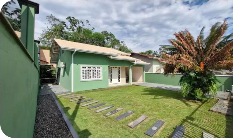 a house in the suburbs with a green at Casa - Joinville in Joinville